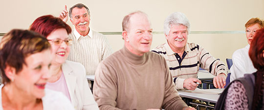 Group of seniors smiling in a classroom